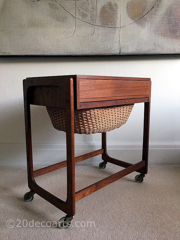  20th Century Decorative Arts | A mid-century modern design Danish sewing table in teak, single drawer partitioned inside in a light wood, above a slide out basket. c1960’s.