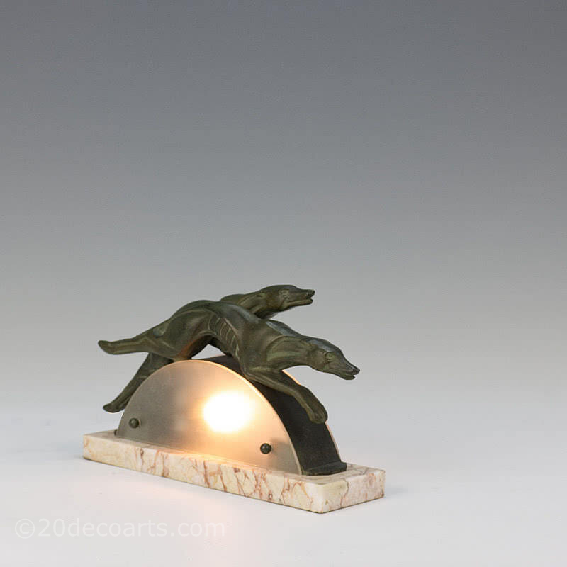  20th Century Decorative Arts |A very stylish art deco spelter lamp, circa 1930s, France - the bronze patinated stylised metal greyhounds leaping over a frosted glass arc, mounted on a marble base 