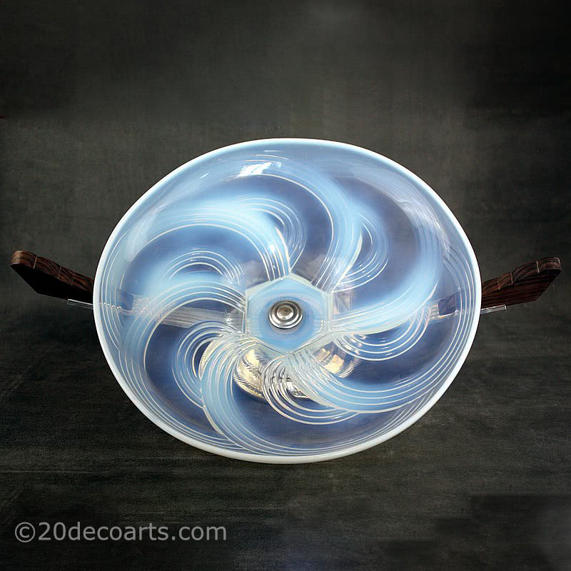  20th Century Decorative Arts |A beautiful Art Deco opalescent glass table centrepiece, 1930s, the glass probably by Cristallerie Choisy-le-Roi France, the polished glass molded with a stylised swirls, mounted on palisander wood and chromed metal