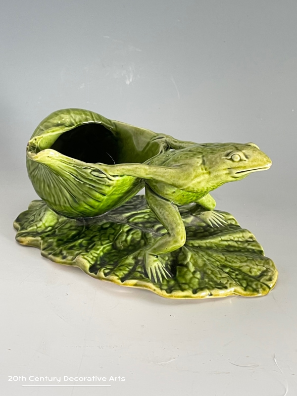  Watcombe Torquay Pottery Frog Spoon Warmer c1880 In the form of a frog on a lily pad / leaf pulling a shell glazed in green.  